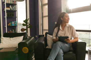 Asian woman using tablet at home office