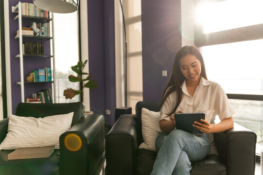 Asian woman using tablet at home office