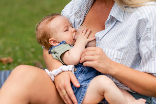 Months Old Baby Breastfeeds From Mother While Outdoors 