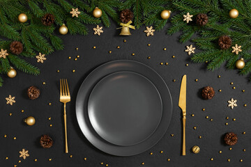 Golden Christmas table setting with festive decorations on a black background. Happy new year....