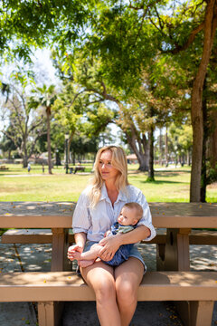 Mother And Her Son Watch People Playing At The Park 