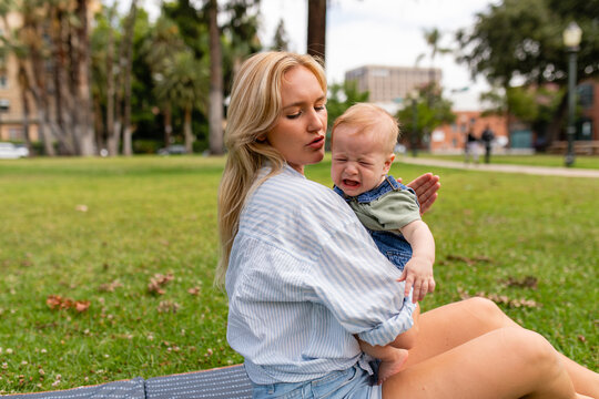 Mother Consoles Crying Baby In The Park