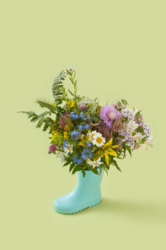 Rubber boot as vase for wildflowers.