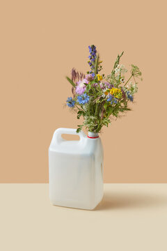 Flowers and herbs in plastic can.