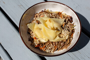 Work with buckwheat noodles, vegetables and Peking duck meat with sesame and ginger, top view, flat lay