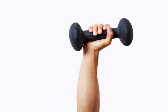 Cropped sportsman raising arm with dumbbell