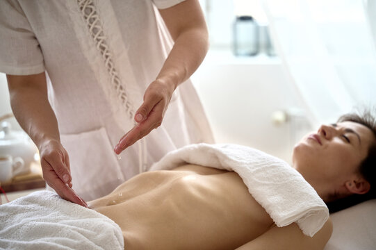 Massage therapist working with a client