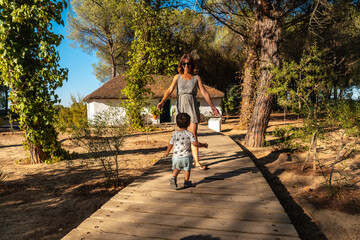 A tourist with her son visiting an old hut in the Doñana Natural Park, Huelva. Andalusia - obrazy, fototapety, plakaty