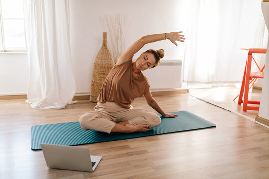 Woman Stretching Her Body, While Practising Yoga