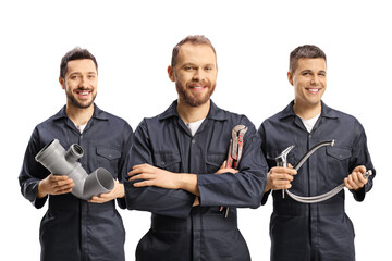 Team of plumbers holding plumbing equipment - obrazy, fototapety, plakaty