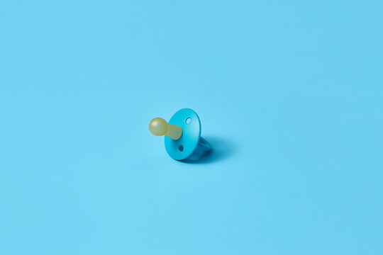 Single newborn dummy on blue background.