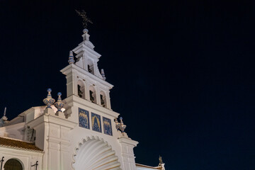 White facade of the sanctuary of Rocio in the fiesta del rocio at night, Huelva. Andalusia