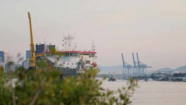 Dredge leaving river towards the sea at sunrise, Itaja&iacute; - Santa Catarina