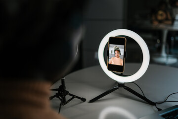 Black woman recording video on smartphone