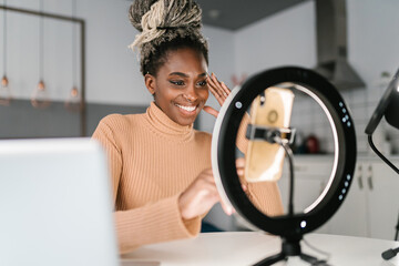 Happy black woman recording vlog