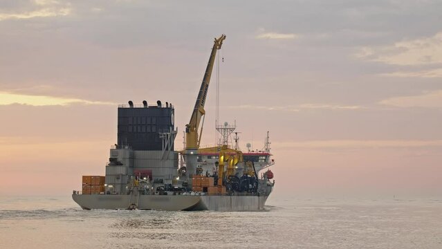 Dredge leaving river towards the sea at sunrise, Itaja&iacute; - Santa Catarina