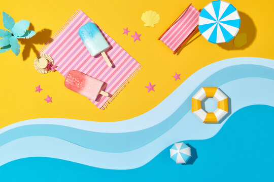 Ice Cream Bar On Towel Under Umbrella On Two Color