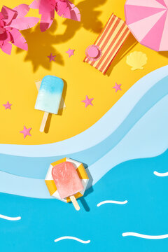 Hello summer text in beach sand with popsicles dessert