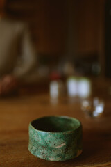 two earthenware cups on a brown table