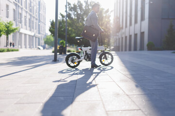 Man in suit riding on electric cycle 