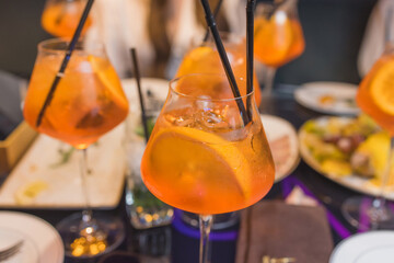 aperol spritz cocktail with pomelo on the table in restaurant.
