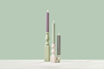 Candles in pastel colors in fancy holders.