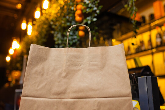 dessert paper bag waiting for customer on counter in modern cafe coffee shop, food delivery, cafe restaurant, takeaway food.