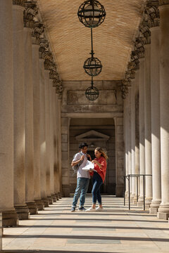Two Friends University Students review assignment on campus Hallway