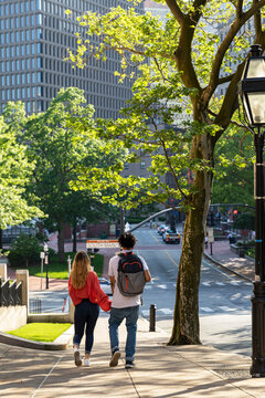 Two cute Friends University Students walk down hill on campus