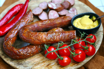 Chopped smoked sausages. Fresh homemade sausages on a wooden board.