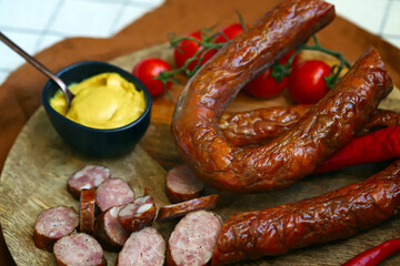 Chopped smoked sausages. Fresh homemade sausages on a wooden board.