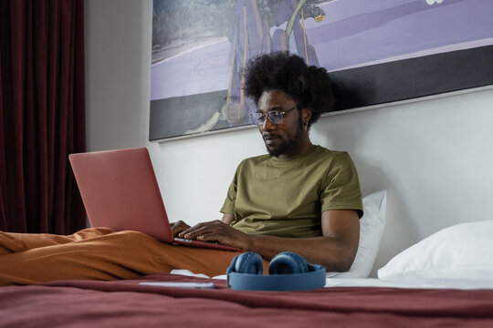 Black Man Typing On Laptop Keyboard