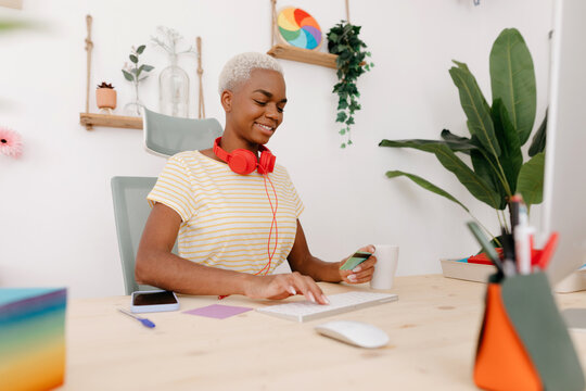 Black Woman Making Online Purchase In Office