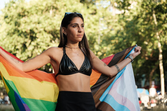 Proud woman holding lgbtqia+ flag