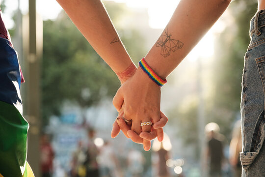 Anonymous lesbian couple holding hands at pride