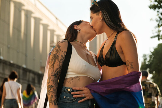 Lesbian couple kissing on pride march