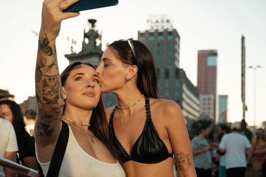 Lesbian couple taking selfie with phone