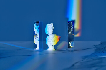 Antique bust and triangular prisms with rainbow.