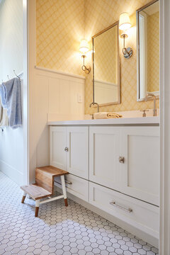 Double vanity sinks in modern design farmhouse bathroom with kid stool