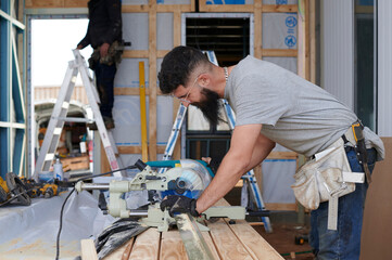 House construction site with tradesmen
