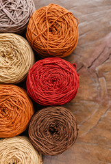 Colorful thread coils for knitting. Knitted and cotton yarn. Autumn palette of colors and yellow shades. Knitting warm products