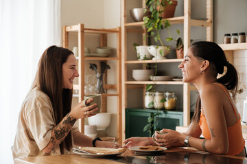 Happy couple taking breakfast in the kitchen