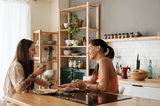 Smiling couple taking breakfast in the kitchen