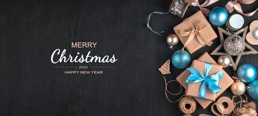 Christmas decorations and gifts on a black background. The concept of Christmas, New Year. Top view, copy space