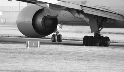 Black and white photo of 777-F port engine and undercarriage - stock photo