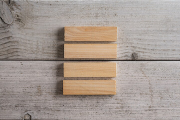 Stack of four blank wooden pegs or blocks
