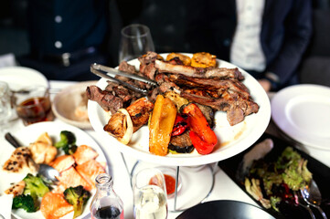 Fresh juicy delicious beef steak on a dark background. Meat dish with spices and herbs