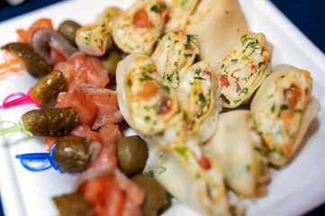 lots of stuffed pancakes and cucumber canapes