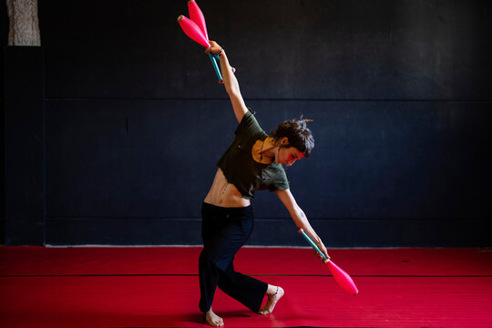 Female Working With Juggling Clubs