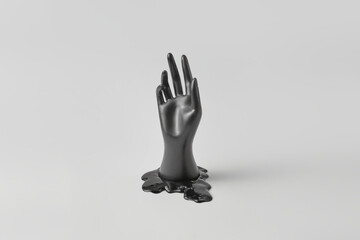 Black hand reach out from puddle of oil.